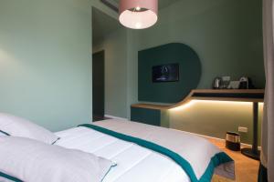 Postel nebo postele na pokoji v ubytování Le Texture Premium Rooms Duomo-Cordusio