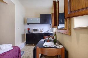 a small kitchen with a table and chairs and a kitchen with at Neri 0 in Florence