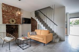 a living room with a chair and a staircase at Vakantiehuis Hana in Heers