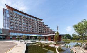 a hotel with a pond in front of a building at Lankaran Springs Wellness Resort in Lankaran