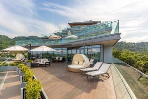 a balcony of a building with chairs and tables at Lankaran Springs Wellness Resort in Lankaran