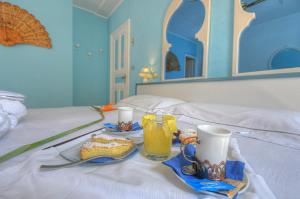 Posteľ alebo postele v izbe v ubytovaní Hotel Arabesque