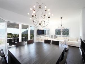 a living room with a large wooden table and a chandelier at The one in Andratx