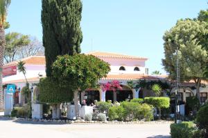 a building with a lot of plants and trees at Rocha Brava Village Resort in Carvoeiro
