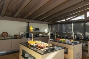 a kitchen with a buffet of food on a counter at Rocha Brava Village Resort in Carvoeiro