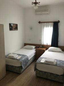 Postel nebo postele na pokoji v ubytování Tay Pansiyon