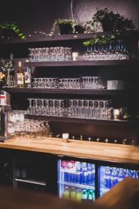 a bar with many empty glasses on the shelf at Fr&oslash;ken Skjolds Hotel Lyngeng&aring;rden in Mosj&oslash;en