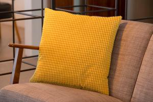 a yellow pillow sitting on top of a chair at Hotel Gullfoss in Haukadalur