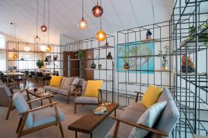 a large room with chairs and tables and a room with at Hotel Gullfoss in Haukadalur