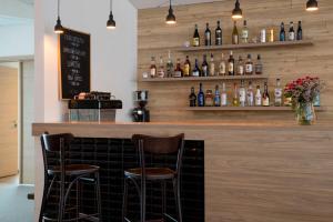 a bar with two chairs and bottles of wine at Hotel Gullfoss in Haukadalur