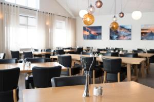 a dining room with wooden tables and chairs at Hotel Gullfoss in Haukadalur