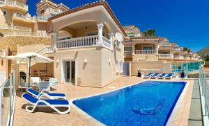a villa with a swimming pool and a house at Villa Guapa With Gym Aircon Wifi Moraira in Moraira
