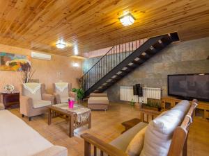 a living room filled with furniture and a staircase at Es rafalot in Binissalem