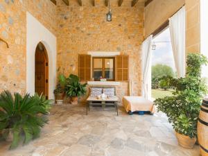 a room with a stone wall with a table and a mirror at Es rafalot in Binissalem