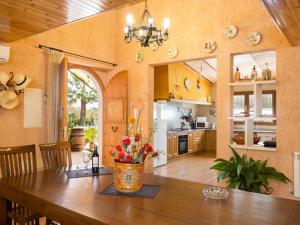 a kitchen with a wooden table with flowers on it at Es rafalot in Binissalem