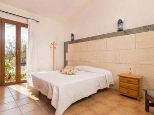 a bedroom with a bed and a cross on the wall at Es rafalot in Binissalem +17 photos