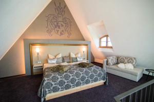 a bedroom with a large bed and a couch at Burg Colmberg Hotel in Colmberg