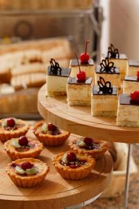 a display of desserts and pies on a table at Barkhatnye Sezony Sportivny Kvartal Resort in Adler