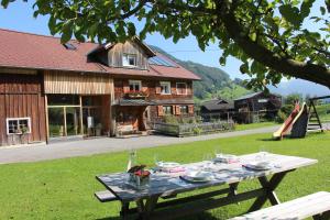 a picnic table in front of a house at Ferienwohnung Vogt in Mellau