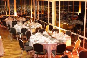 a dining room with tables and chairs and a large window at Sol San Javier in San Javier