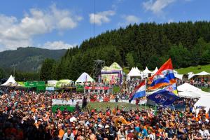 a large crowd of people standing around at a festival at GrandPrixCamp, closest to the Red Bull Ring, up to 4 guests in a tent in Spielberg