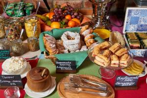 a table with a bunch of different types of food at Alexander House in Saint Petersburg
