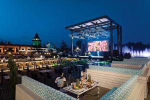 a view of a patio with a stage and tables at Mardan Palace in Lara