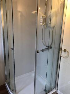 a shower with a glass door in a bathroom at But & Ben in Balloch in Balloch