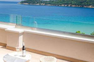 a bottle of wine sitting on a table in front of a window at Agorastos Hotel in Koinyra