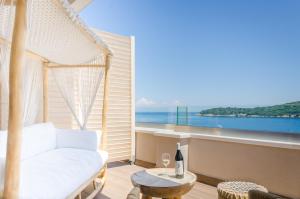 a living room with a white couch and a view of the ocean at Agorastos Hotel in Koinyra
