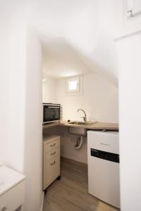 a small kitchen with a sink and a microwave at Lovely Studios In Mykonos Old Town in Mýkonos City