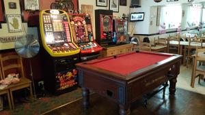 a room with two arcade games and a pool table at St Albans Hotel in Blackpool