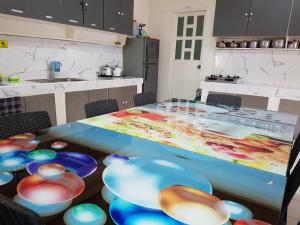 a kitchen with a table with colorful bowls on it at OMG Guesthouse Room for 2 in Licup