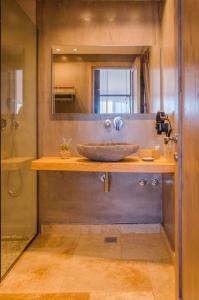 a bathroom with a wooden counter with a sink at Agorastos Hotel in Koinyra