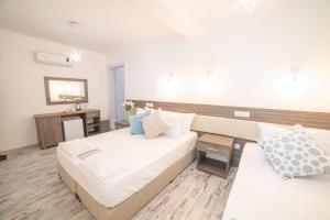 Postel nebo postele na pokoji v ubytování Madda Hotel