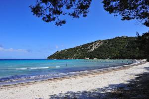 a view of a beach with the ocean at Résidence Mobydick in Porto-Vecchio