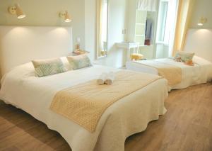 a bedroom with two beds with towels on them at Chez Laurette in Saint-Remèze