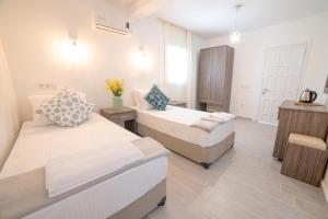 Postel nebo postele na pokoji v ubytování Madda Hotel