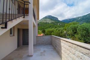 a balcony of a house with a view of mountains at Villa Nikola - big terrace apartments in Bol