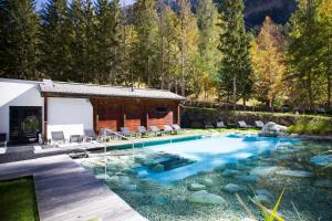a swimming pool with a pool table in front of it at Le Bristol Leukerbad in Leukerbad