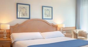 a bedroom with a bed and two pictures on the wall at SH Villa Gadea in Altea