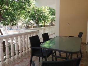 a table and chairs on a balcony with a window at Turtle Beach Apartment in Marathias