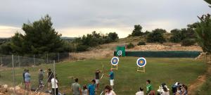 un grupo de personas de pie en un campo con señales en Long View Hammam & Spa, en Porto Heli