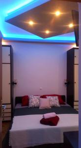 a bedroom with a bed with blue lights on it at Dalmatino in Brodarica