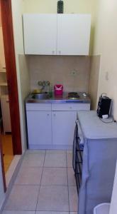 a small kitchen with a sink and a counter at Dalmatino in Brodarica