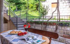 a table with a plate of fruit and bread on it at Holiday Home Nada in Tučepi +20 photos