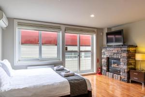 a bedroom with a bed and a fireplace and a television at Fresh Powder Accommodation in Furano