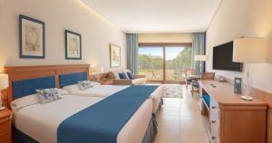 a hotel room with a large bed and a television at SH Villa Gadea in Altea