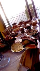 a table topped with plates of food at Borgo San Francesco in Gioiosa Marea