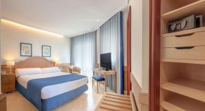 a hotel room with a bed and a television at SH Villa Gadea in Altea
